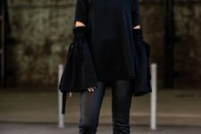 14 a black oversized ripped sweater, black leather pants, a black bag and heeled loafers