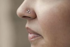 14 a triple nose stud piercing is a bold and unique idea for a daring girl