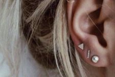 14 stylish boho ear accessorizing with several ear studs and two hoops iin the helix looks very relaxed