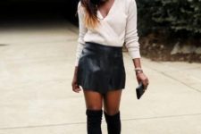 With black leather mini skirt, black high boots and clutch