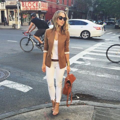 With brown blazer, white top, brown backpack, distressed jeans and high heels