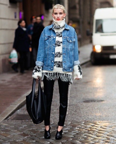 With denim jacket, black tote bag, black trousers and ankle boots