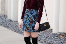 With floral mini skirt, black small bag and black over the knee boots
