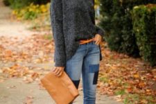 With gray loose sweater, brown belt, brown clutch and cutout ankle boots