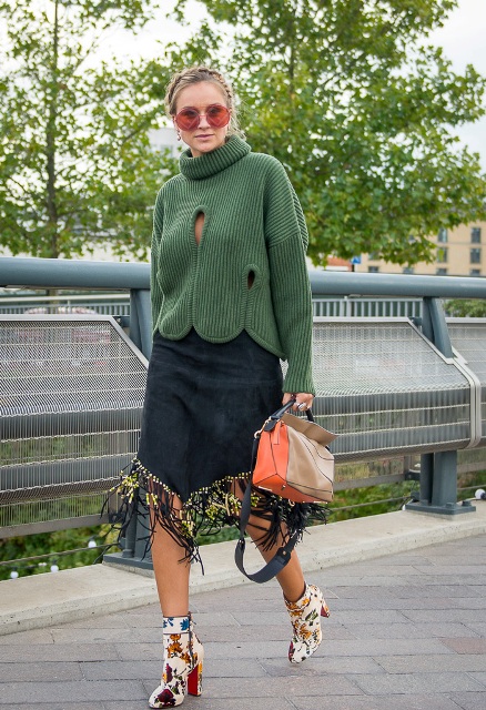 With green sweater, fringe skirt and three colored bag
