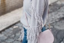 With pale pink bag and jeans