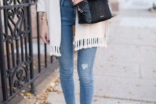 With skinny jeans, white shirt, black crossbody bag and beige boots