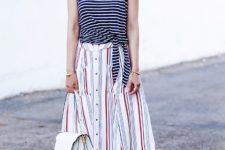With striped top, white bag and embellished sandals