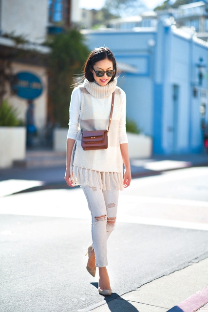 With white distressed pants, brown leather mini bag and pumps