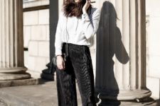 With white loose shirt, chain strap bag and black culottes