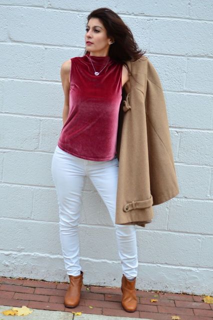 With white pants, beige coat and brown leather ankle boots
