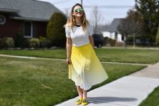 With white t-shirt and yellow embellished flat shoes