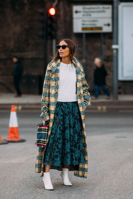 With white t-shirt, plaid bag, white ankle boots and printed midi skirt