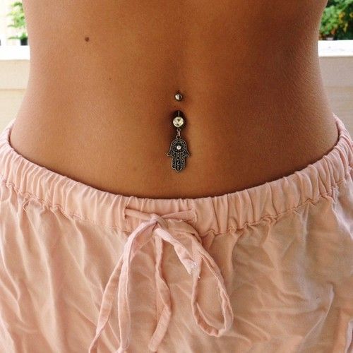a boho belly button piercing with a hanging hand with rhinestone is a bold idea for a boho girl
