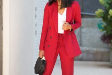 a bright red pantsuit, a white top, colorful pumps and a black geometric bag for an ultimate office look