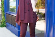 a burgundy striped suit with fitting cropped pants, a blush shirt and blush pumps for a wow effect