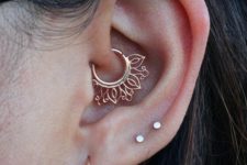 a hoop and two tiny studs plus a boho gold ring in the daith for a boho look