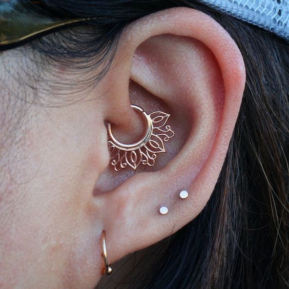 a hoop and two tiny studs plus a boho gold ring in the daith for a boho look