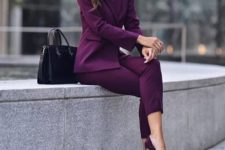 a monochromatic purple pantsuit, matching velvet pumps and a black bag to make a bold statement