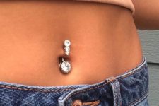 a multi gem belly button piercing is a bold and shiny idea for a modern and bold look