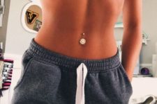 a shiny floral belly button piercing is a chic ad girlish idea to show off your belly