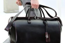 a sleek black leather travel bag with touches of pink is an ultra-modern idea with plenty of style