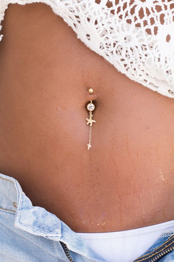 a starfish belly charm with a tiny gold seashell on the chain and a rhinestone is a cute idea for the beach