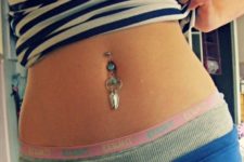 bold boho chic belly button piercing with stylized dream catchers with turquoise beads and feathers