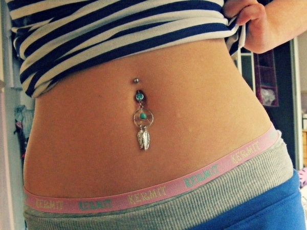 bold boho chic belly button piercing with stylized dream catchers with turquoise beads and feathers