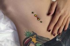 colorful ball belly button piercings to match the colorful tattos on the belly