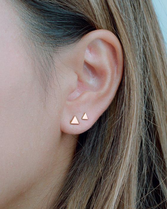 a duo of minimalist gold triangle studs will give a chic minimal feel to your look