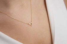 03 a gold frame triangle necklace on a very thin chain is a very delicate accessory to try