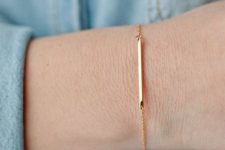 04 a gold chain bracelet with a thin metal bar that accentuates your look and make it trendy