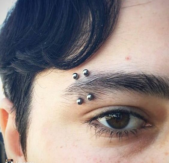 double dark stud male eyebrow piercing will accent your look a lot