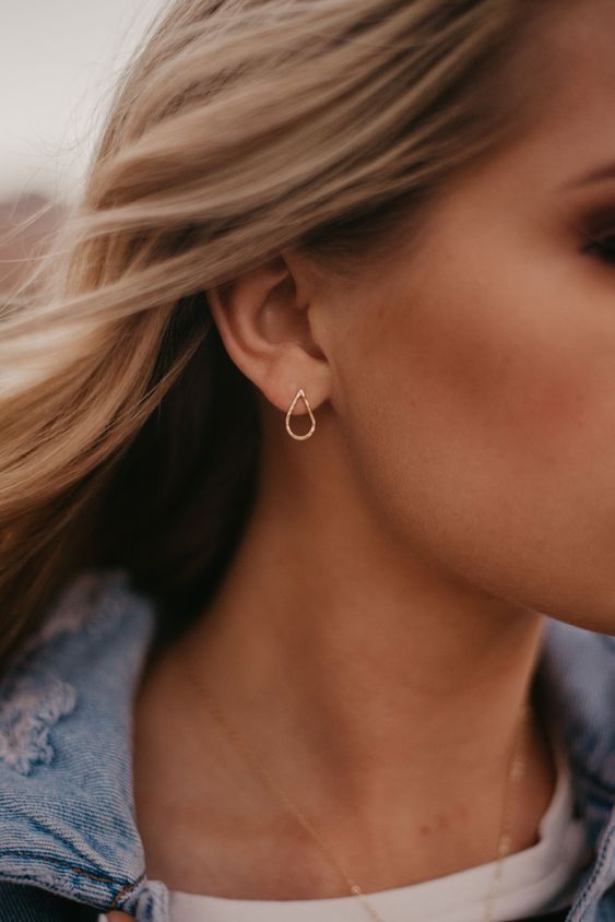 a gorgeous hammered teardrop stud earring in gold and a single chain are all you need for a classy look
