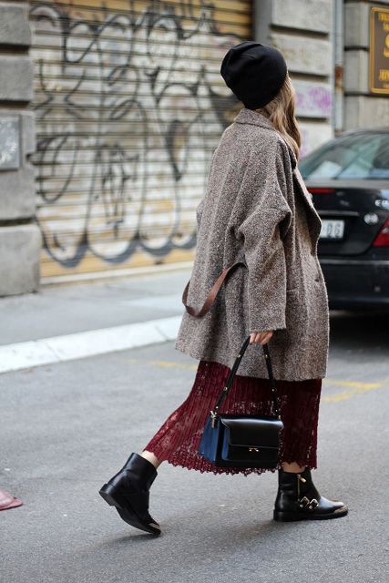 With black hat, gray loose coat, black and blue bag and flat boots