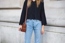With black loose blouse, brown leather bag and loose jeans