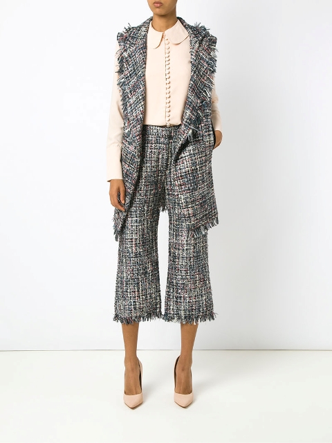With blouse, tweed long vest and beige pumps