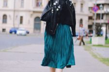 With emerald midi skirt and golden shoes