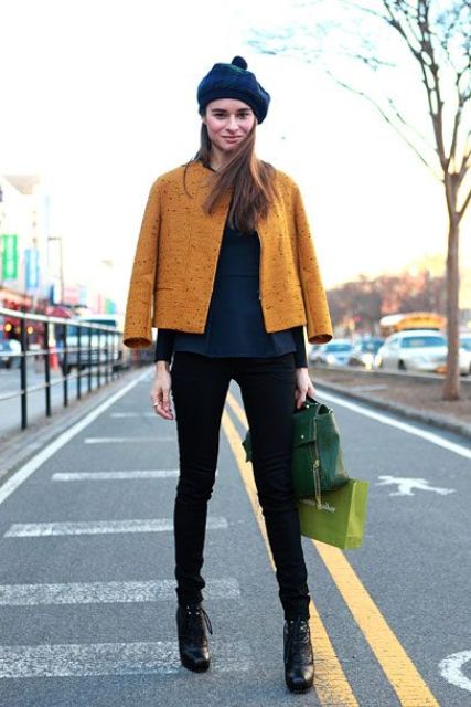 With emerald shirt, black pants, yellow jacket, green bag and ankle boots