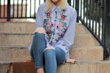 With floral blouse, distressed jeans and brown bag