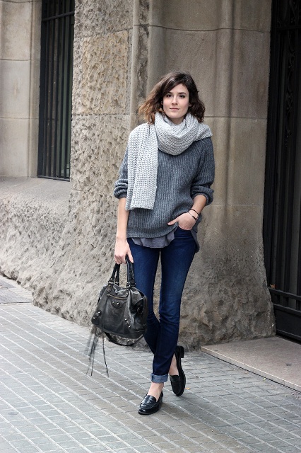 With gray sweater, gray scarf, black bag and cuffed jeans