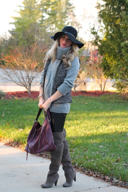 With gray turtleneck sweater, black wide brim hat, black skinny pants, gray over the knee boots and purple bag