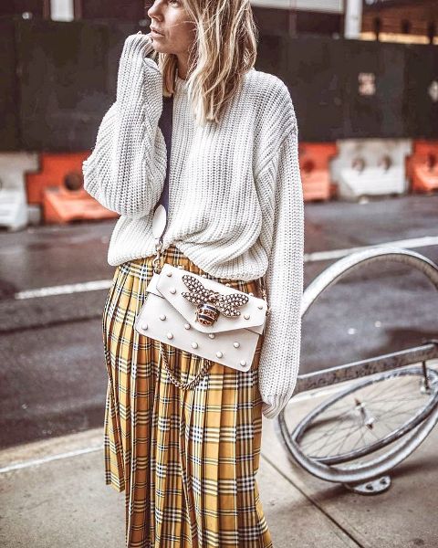 With light gray oversized sweater and embellished crossbody bag