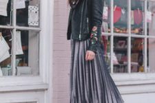 With metallic pleated skirt and black boots