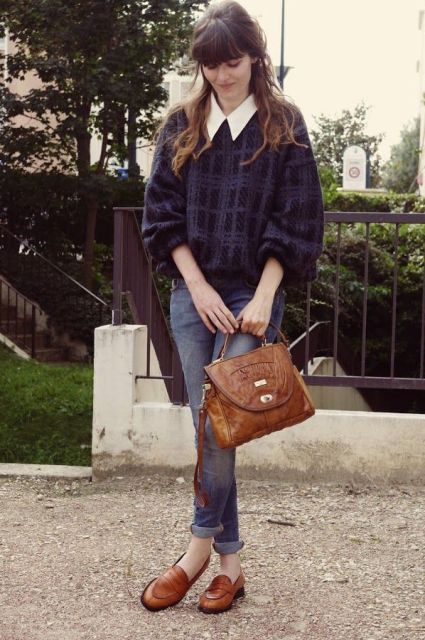 With plaid loose sweater, white shirt, cuffed jeans and brown bag