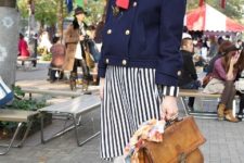 With striped skirt, navy blue jacket, brown leather bag and platform shoes
