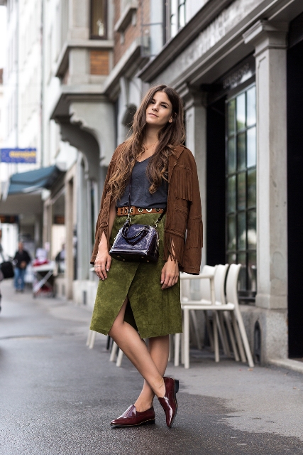With top, green wrapped skirt, crossbody bag and suede fringe jacket