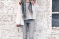 With white bell sleeved sweater, gray pom pom scarf, gray skinny jeans and lace up boots