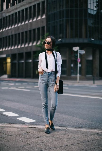 With white button down shirt, black bag and high-waisted jeans